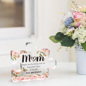 Detail of puzzle-shaped acrylic plaque with floral UV printing and mother's day quote