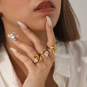 Detailed view of gold plated zircon rings with marquise and pear cut stones on hand