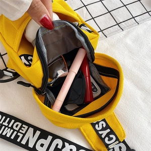 Interior view of yellow canvas crossbody bag showing large capacity for essentials