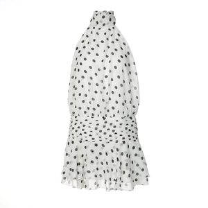Detail of white halter neck top with black polka dots and pleated ruffled hemline