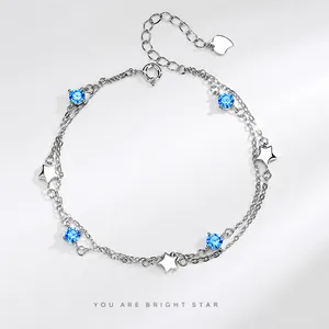 Detail of S925 silver double-layer bracelet with blue zircon stones and star charms