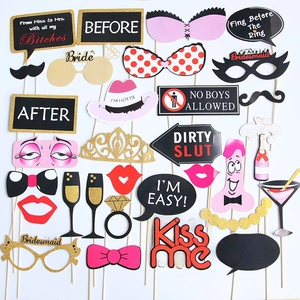Close-up of assorted foil photo booth props including humorous party signs and eyewear