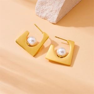 Gold stainless steel irregular geometric earrings featuring white pearls on a stone base