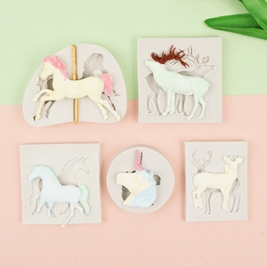 Detail showing silicone molds and finished shapes of unicorn, carousel, and elk figurines