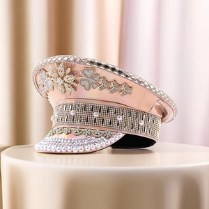 Macro shot of rose gold captain hat with rhinestones, pearls and floral crystal patterns