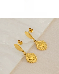 Detailed view of vintage heart-shaped earrings featuring 18K gold plating and ornate texture