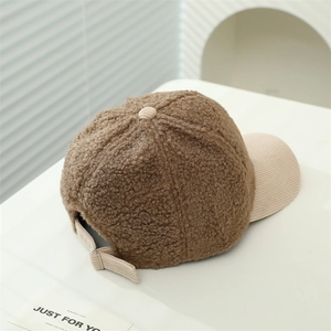 Detail of lamb wool baseball cap with corduroy brim and adjustable metal buckle strap