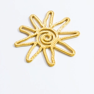 Detailed view of sun-shaped 18K gold plated stainless steel pendant with textured spiral design