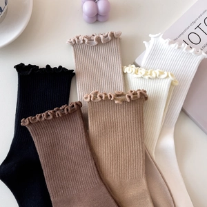 Collection of warm-toned cotton ruffle socks in various earthy colors with ribbed texture