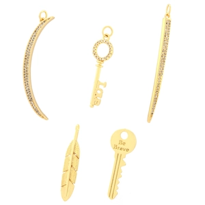 Gold plated pendants collection featuring moon, key, and feather designs with zircon