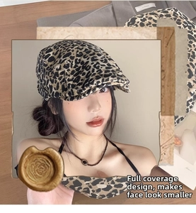 Detail of vintage leopard print beret hat showing texture and full-wrap shape