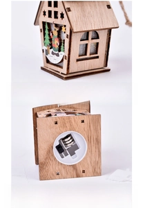 Detail view of wooden Christmas cabin with reindeer carvings and battery base