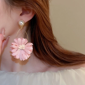 Elegant pink fabric flower earrings with faux pearl detail worn by model for a sweet look