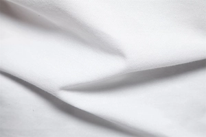 Macro shot of breathable white cotton pique fabric texture on polo shirt detail