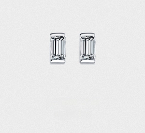 Macro detail of emerald cut zircon studs with minimalist rectangular silver settings