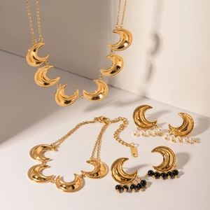Detail view of 18k gold plated stainless steel crescent moon jewelry set with pearls
