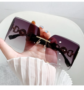 Detail of purple gradient oversized sunglasses with gold hollowed metal temples