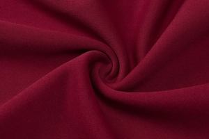 Macro texture of wine red knitted fabric with soft spiral pattern and high quality finish
