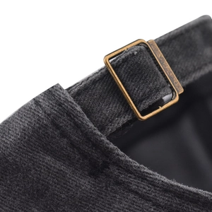 Close-up of vintage bronze metal buckle and washed cotton texture on baseball cap back
