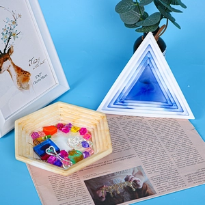 DIY silicone mold for resin tray showing hexagonal designs and colorful resin pieces