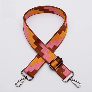 Detail of adjustable thick woven strap with pink geometric pattern and gunmetal hooks