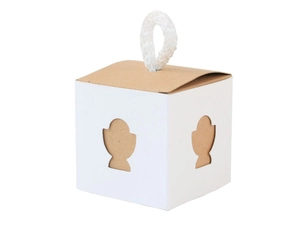 Detail of square kraft paper candy box featuring white sides and hollow cross pattern