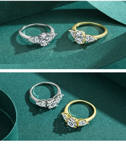 Close-up of three-stone engagement ring with pear-shaped side stones and pavé band