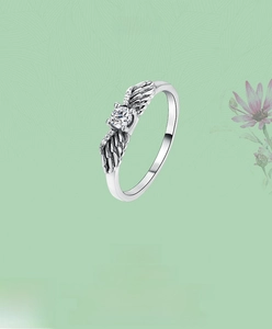 Detailed macro view of S925 silver angel wing ring with round clear zircon centerpiece