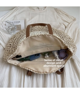 Detail view of woven beach bag interior showing large capacity and zipper pocket