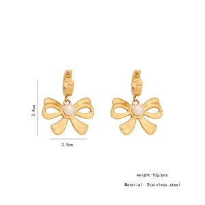Detailed size view of golden bow earrings with white pearls and stainless steel specs