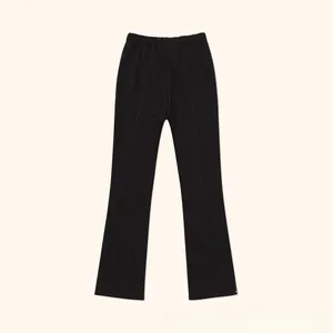 Detailed view of black high-waisted flared sweatpants with elastic waist and soft knit texture