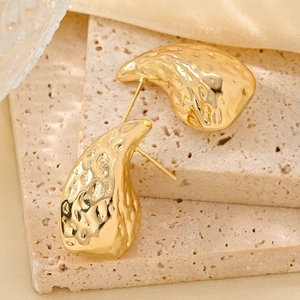 Detailed macro view of 14K gold-plated irregular teardrop earrings with hammered texture