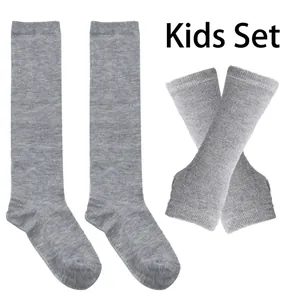 Macro detail of grey ribbed knit textures on children's long socks and arm warmers set