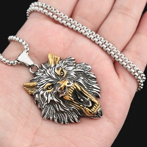 Detail of Viking wolf head pendant with gold accents on a silver stainless steel chain