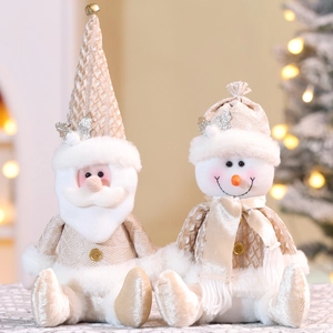 Champagne gold sitting Santa and Snowman plush figurines with festive sequin details