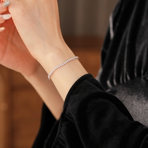 Close-up of elegant lavender pearl bead bracelet on wrist with a minimalist vintage look
