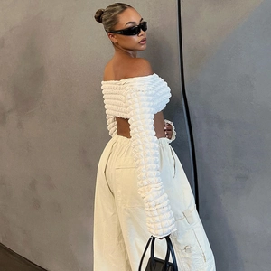 White off-shoulder bubble texture crop top with long sleeves and open back design