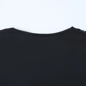 Close-up of black V-neck top showing delicate lace stitching and high-quality fabric texture