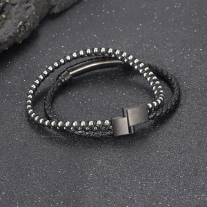 Close-up of black braided leather and beaded stainless steel bracelet with magnetic clasp