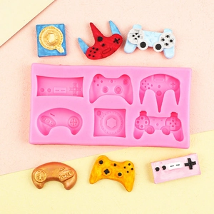 Pink silicone mold featuring retro game controller shapes for DIY cake and craft decor