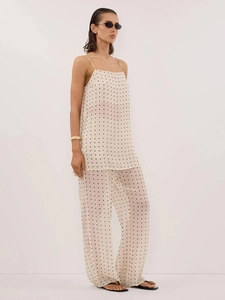 Close-up of semi-transparent polka dot fabric on a two-piece summer camisole and pants set