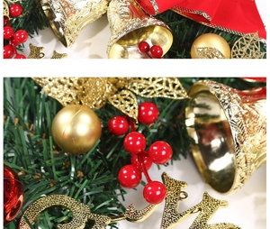 Detailed macro of Christmas wreath featuring golden bells, red berries, and pine needles