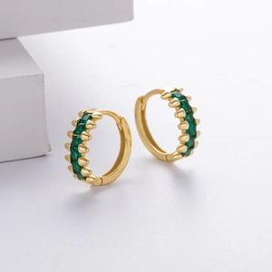 Detail of gold S925 sterling silver hoop earrings with micro-set green zirconia