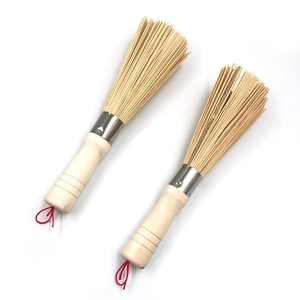Natural bamboo pot cleaning brushes with wooden handles and hanging loops on white background