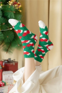 Close-up of thick coral fleece Christmas socks with festive snowflake patterns
