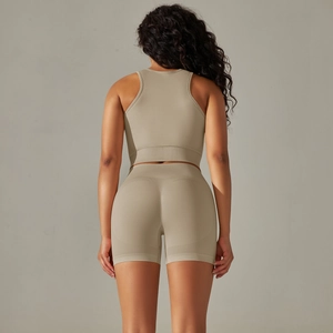 Detail of cross-back straps on seamless yoga bra and high-waist shorts in beige