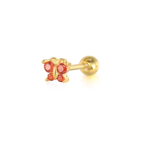 Close-up of golden butterfly stud earring with red gemstones and screw back design