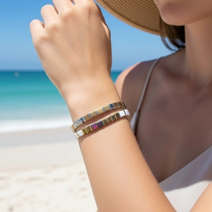 Detail view of Bohemian Tila bead bracelets featuring golden, white and blue stacked tiles