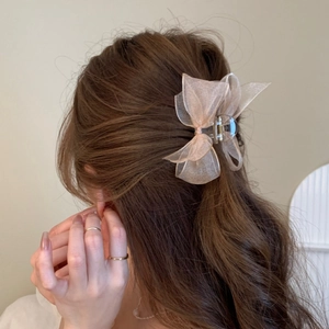 Elegant champagne pink organza bow hair claw clip for a stylish side hairstyle