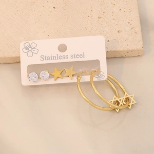Detailed macro view of 3-pair gold stainless steel earring set with star and zircon motifs